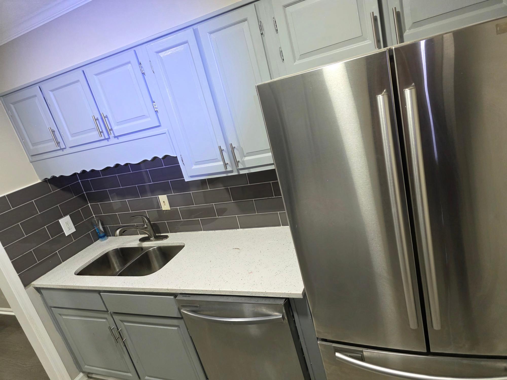 Kitchen with quartz counters and subway tile backsplash