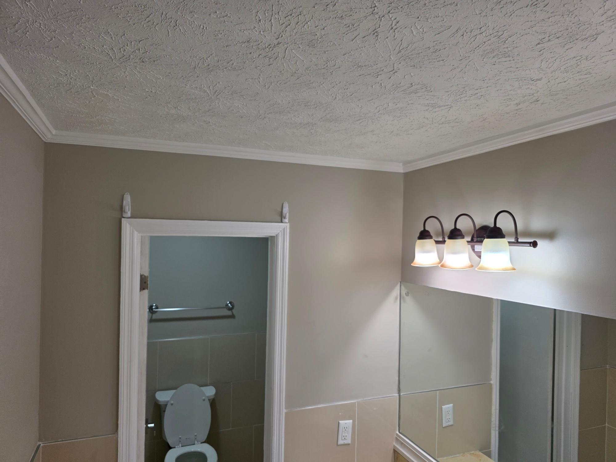 Full bathroom vanity with mirror and sconce lighting
